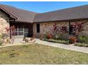 Well-maintained brick exterior with landscaping, including vibrant foliage and a manicured lawn at 1990 Spruce Creek N Cir, Port Orange, FL 32128