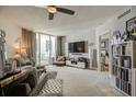 Cozy living room featuring a sliding glass door, neutral walls, and ceiling fan and built in shelving at 241 Riverside Dr # 207, Daytona Beach, FL 32117