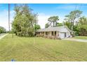 Charming single-story home featuring a well-manicured lawn and attached garage on a sunny day at 28 W Highbanks Rd, Debary, FL 32713