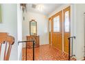 Bright foyer with unique tiled floor, wooden accents and a mirror above a console table at 28 W Highbanks Rd, Debary, FL 32713