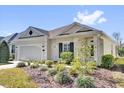 Inviting single-story home with a well-maintained yard featuring lush landscaping at 307 Heron Point Way, Deland, FL 32724