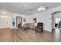 Open-concept living room with hardwood flooring, neutral paint, and ample natural light at 307 Heron Point Way, Deland, FL 32724