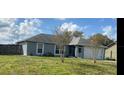 Cozy single-story home with a well-manicured lawn and attached two-car garage at 3209 S Dorchester Dr, Deltona, FL 32738