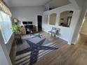 Inviting living room featuring wood floors, a large window, and a stylish starfish rug at 3209 S Dorchester Dr, Deltona, FL 32738