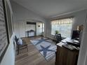 Bright living room with a large window, wood floors, and stylish decor at 3209 S Dorchester Dr, Deltona, FL 32738