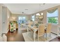 Bright dining area featuring a white table set for four with coastal decor and hardwood floors at 37 Fairway Ct # C, Deland, FL 32724