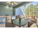 A beautiful covered patio featuring an outdoor kitchen and comfortable seating for dining and lounging at 376 Chelsea Place Ave, Ormond Beach, FL 32174