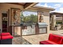 Outdoor kitchen features a stainless steel grill, granite counters, and storage at 3955 Equine Cv, Lake Mary, FL 32746