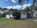 Picture of single-story home with well-manicured lawn and attached two-car garage at 4164 New Marsh Rd, Deland, FL 32724
