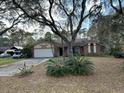 Charming single-story home with a two-car garage and mature landscaping in a quiet neighborhood at 4164 New Marsh Rd, Deland, FL 32724