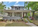 Inviting home exterior featuring a cozy front porch with swing and beautiful landscaping at 427 E Church St, Deland, FL 32724