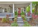 Charming front porch with red door, ceiling fan, and potted plants at 427 E Church St, Deland, FL 32724