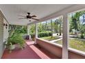 View of a front porch featuring a ceiling fan, painted floor, and a view of the front yard at 427 E Church St, Deland, FL 32724