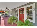 A welcoming front porch with a swing, ferns, and a view of the street with number 427 at 427 E Church St, Deland, FL 32724