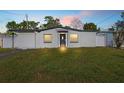 Exterior view of the home featuring a well-manicured lawn and a simple, modern architectural design at 4333 Arch St, Orlando, FL 32808