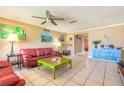 A bright living room featuring tile floors, ceiling fan and neutral wall paint at 44 Sunset Blvd, Ormond Beach, FL 32176