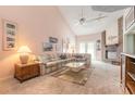 Spacious living room featuring a fireplace, vaulted ceilings and lots of natural light at 60 N Halifax Dr # 1050, Ormond Beach, FL 32176