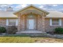 Inviting front porch of a brick home, enhanced by decorative columns and tiled entryway at 600 Tabatha Dr, Osteen, FL 32764