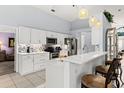 Bright kitchen boasting white cabinets and stainless steel appliances at 6408 Whit Ct, Port Orange, FL 32128