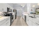 Modern kitchen featuring stainless steel appliances and white cabinetry at 6408 Whit Ct, Port Orange, FL 32128