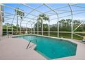 Relaxing screened-in pool with views of the scenic pond at 6408 Whit Ct, Port Orange, FL 32128