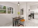 Bright breakfast nook featuring a small table with stools, a window, and kitchen access at 761 Greenway Pl, Daytona Beach, FL 32114