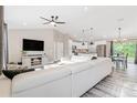 Open-concept living room with modern furnishings and seamless transition to the kitchen at 815 Charles Ave, Orange City, FL 32763