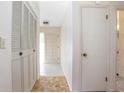 Interior hallway view with tile flooring, a closet with louvered doors, and entry to the bathroom at 902 Cloverleaf Blvd, Deltona, FL 32725