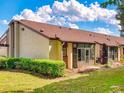 Condo featuring a private screened porch, well-maintained lawn, and mature landscaping at 101 Grand Plaza Dr # G60, Orange City, FL 32763