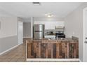 Stylish kitchen features a stainless steel refrigerator, granite counters, and ample cabinet space at 1020 Alladin Dr, Deltona, FL 32725