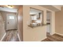 Bright kitchen area featuring a granite countertop, tile backsplash, and white cabinets at 108 Mitchell Pl # 108, Daytona Beach, FL 32118