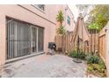 Private patio space featuring a grill, leafy plants, and a decorative umbrella for outdoor enjoyment at 108 Mitchell Pl # 108, Daytona Beach, FL 32118