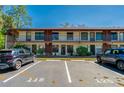 Condo exterior with parking spaces and second story units, perfect for convenient living at 112 Lacosta Ln # 115, Daytona Beach, FL 32114