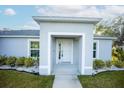 Inviting entrance with a covered porch and decorative landscaping, enhancing the home's appeal at 1162 Prescott Blvd, Deltona, FL 32738