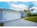 Home featuring a large garage and driveway, providing ample parking space and curb appeal at 1162 Prescott Blvd, Deltona, FL 32738