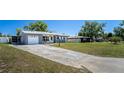 A single-story home featuring a garage and front yard at 1199 Galgano Ave, Deltona, FL 32725