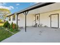 Inviting front porch with an elegant white door and stylish black accents at 1265 Aquarius Ave, Deland, FL 32724