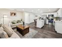 Open-concept living space with a modern kitchen, sleek flooring, and cozy seating area at 1265 Aquarius Ave, Deland, FL 32724
