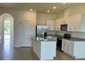 Bright kitchen with white cabinets, stainless steel appliances, and granite countertops on a large island at 131 Reena Dr, Daytona Beach, FL 32117