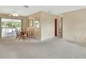 Cozy dining area featuring a glass table, rattan chairs, and sliding glass doors to the porch at 1320 Bakersfield Ave, Deltona, FL 32725