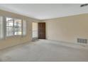 Bright living room with a large window and front door, offering ample natural light at 1320 Bakersfield Ave, Deltona, FL 32725