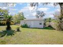 Spacious backyard featuring a detached structure, lush greenery, and privacy fencing at 140 E Faith Ter, Maitland, FL 32751