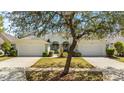 Attractive single-story home with symmetrical facade, two-car garage, and lush front lawn at 1422 Carlow Cir, Ormond Beach, FL 32174
