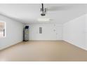 Well-maintained garage with smooth flooring and utility features, for parking and storage at 1422 Carlow Cir, Ormond Beach, FL 32174