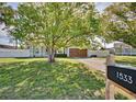 Inviting home with mature trees, lush lawn, and decorative white picket fence at 1533 Legend Ct, Deltona, FL 32738