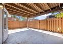 Open-air patio space with wood beam ceiling and a wood fence that offers a private backyard setting at 171 Moonstone Ct, Port Orange, FL 32129