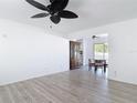 Open living room with light-colored wood flooring, neutral walls and a view of the dining room at 1767 Valencia Ave, Ormond Beach, FL 32174