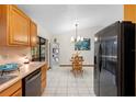 Eat-in kitchen area featuring stainless steel appliances, tiled floors, and large window at 1880 N Merrick Dr, Deltona, FL 32738