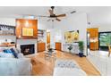 Bright living room featuring a fireplace, hardwood floors, and an open layout to the kitchen at 1880 N Merrick Dr, Deltona, FL 32738