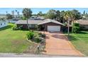Inviting single-story home with a long driveway, mature landscaping and a well-manicured front lawn at 354 Georgetown Dr, Daytona Beach, FL 32118